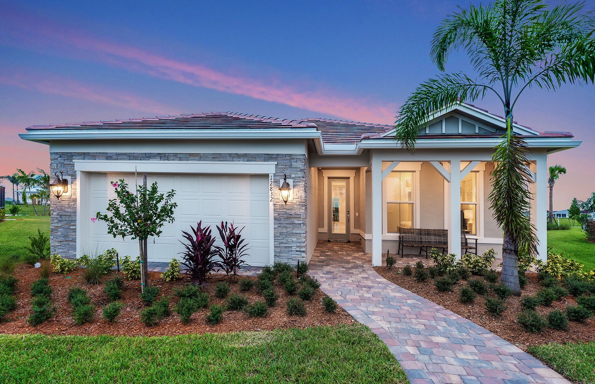 Front exterior of a new home in Del Webb Tradition, Port St. Lucie, FL, highlighting curb appeal (Image 1). Front exterior of a new home in Del Webb Tradition, Port St. Lucie, FL, highlighting curb appeal (Image 1).