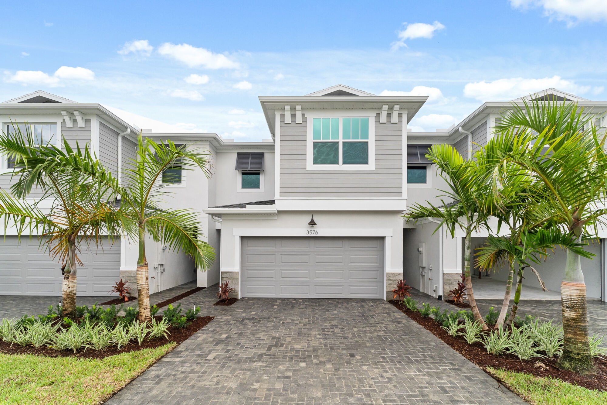 Front exterior of a new home in Avila, Jensen Beach, FL, highlighting curb appeal (Image 1).