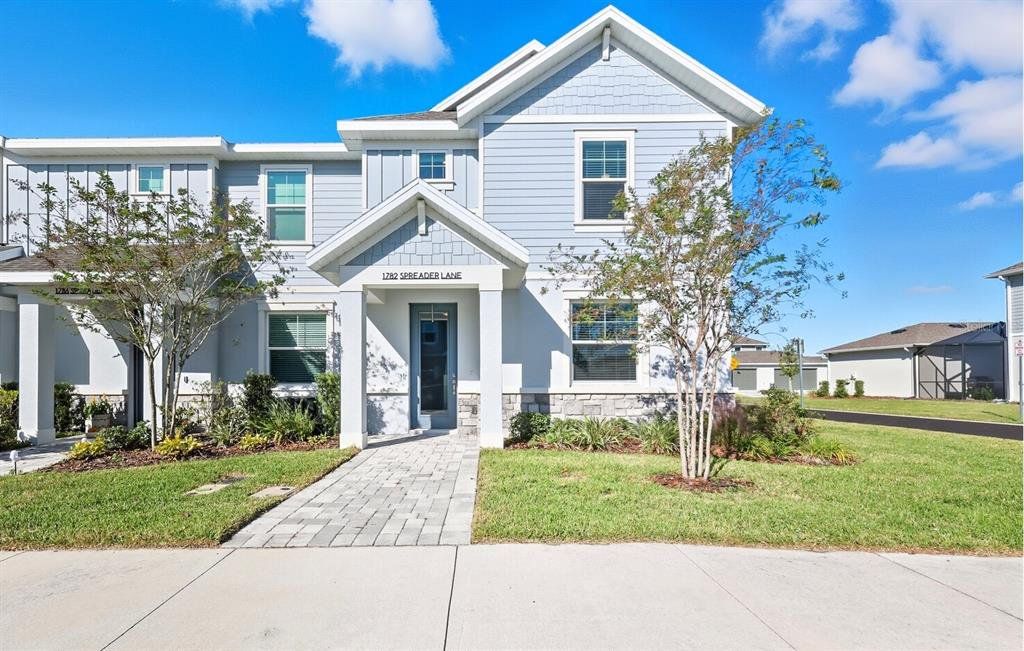 Front exterior of a new home in Nautique at Waterside, Sarasota, FL, highlighting curb appeal (Image 1). Front exterior of a new home in Nautique at Waterside, Sarasota, FL, highlighting curb appeal (Image 1).