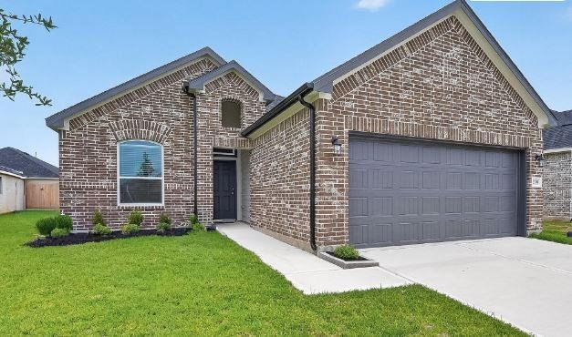 Front exterior of a new home in Grand Magnolia, Magnolia, TX, highlighting curb appeal (Image 1). Front exterior of a new home in Grand Magnolia, Magnolia, TX, highlighting curb appeal (Image 1).
