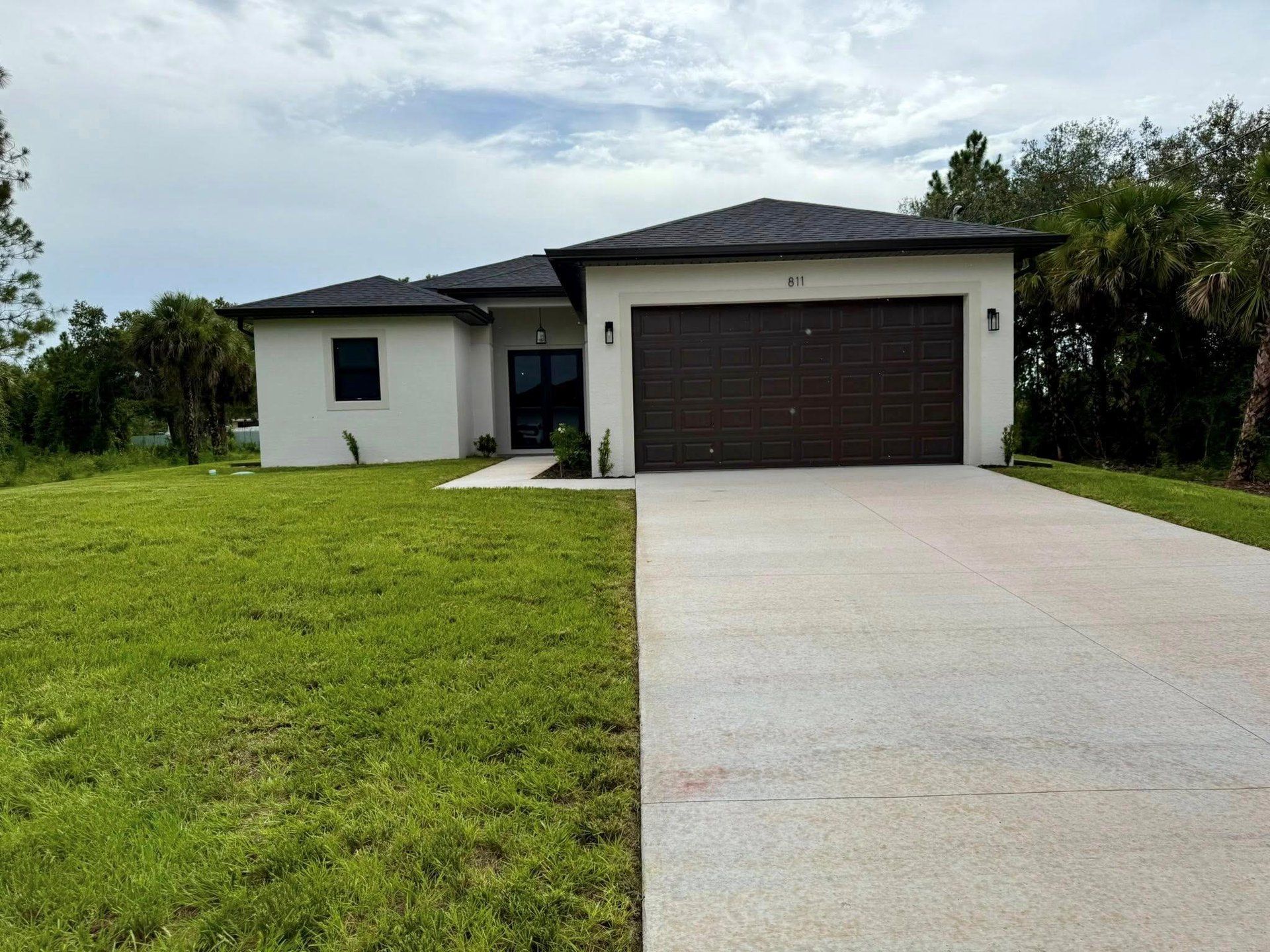 Front exterior of a new home in , Lehigh Acres, FL, highlighting curb appeal (Image 1).