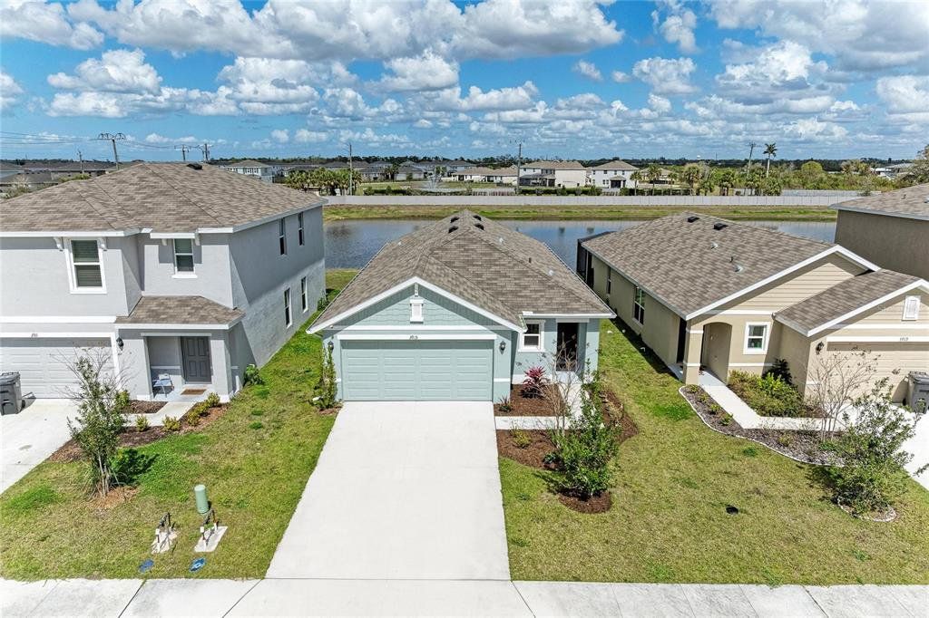 Front exterior of a new home in Evergreen, Bradenton, FL, highlighting curb appeal (Image 1). Front exterior of a new home in Evergreen, Bradenton, FL, highlighting curb appeal (Image 1).
