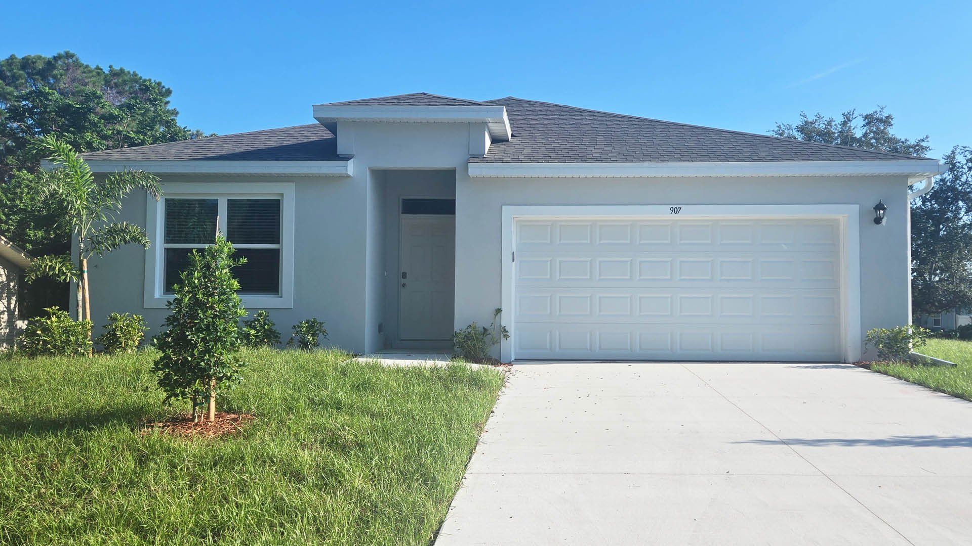 Front exterior of a new home in Palm Bay, Palm Bay, FL, highlighting curb appeal (Image 1).