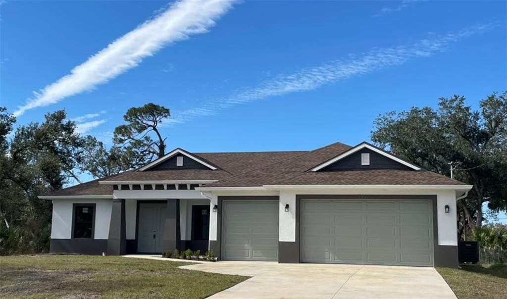 Front exterior of a new home in , North Port, FL, highlighting curb appeal (Image 1). Front exterior of a new home in , North Port, FL, highlighting curb appeal (Image 1).