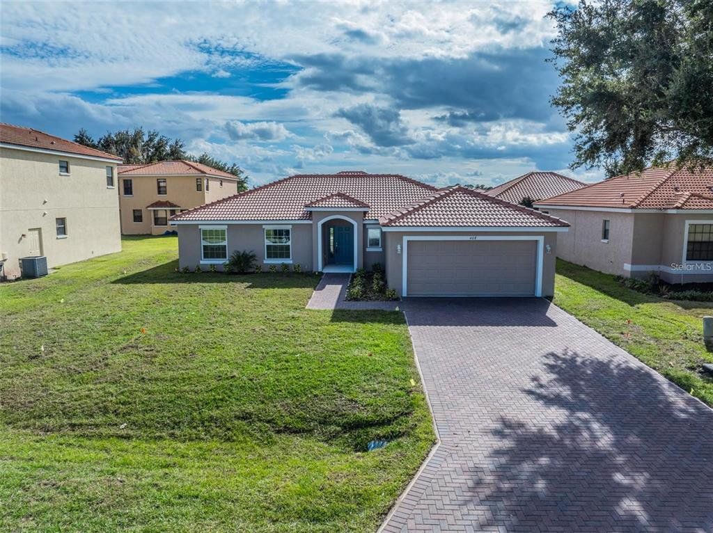 Front exterior of a new home in , Kissimmee, FL, highlighting curb appeal (Image 1). Front exterior of a new home in , Kissimmee, FL, highlighting curb appeal (Image 1).