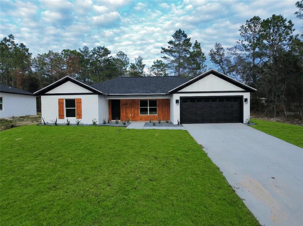 Front exterior of a new home in , Citrus Springs, FL, highlighting curb appeal (Image 1). Front exterior of a new home in , Citrus Springs, FL, highlighting curb appeal (Image 1).