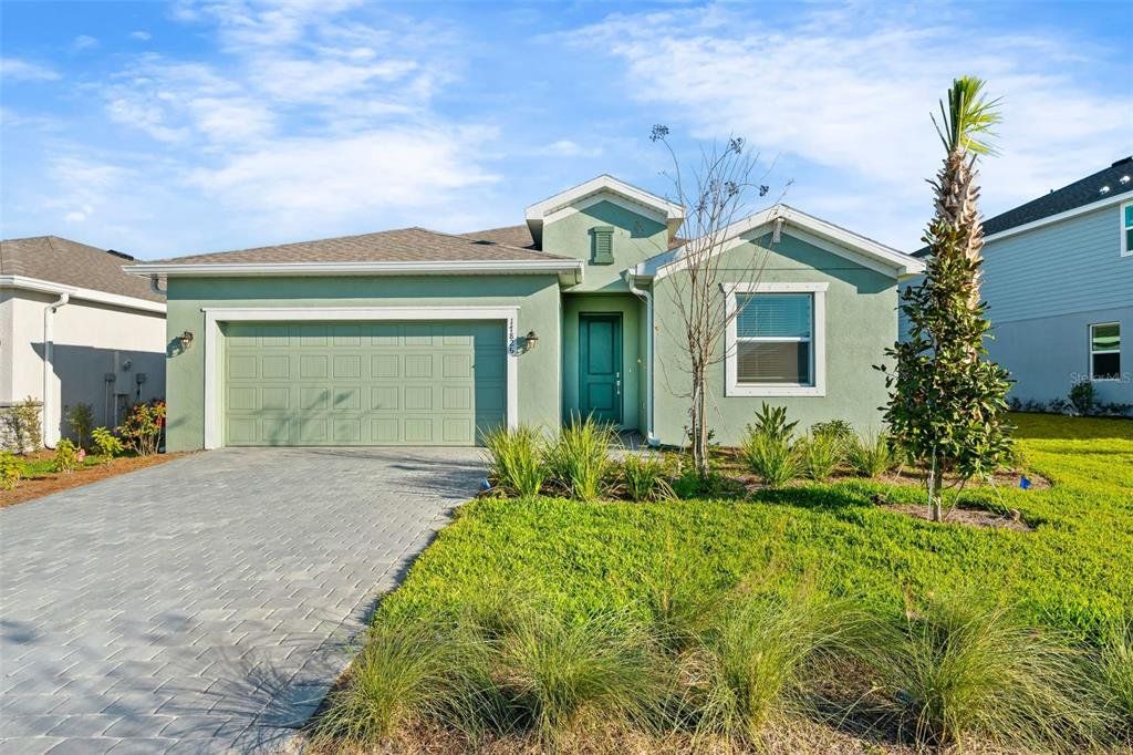 Front exterior of a new home in Rye Ranch, Parrish, FL, highlighting curb appeal (Image 1). Front exterior of a new home in Rye Ranch, Parrish, FL, highlighting curb appeal (Image 1).