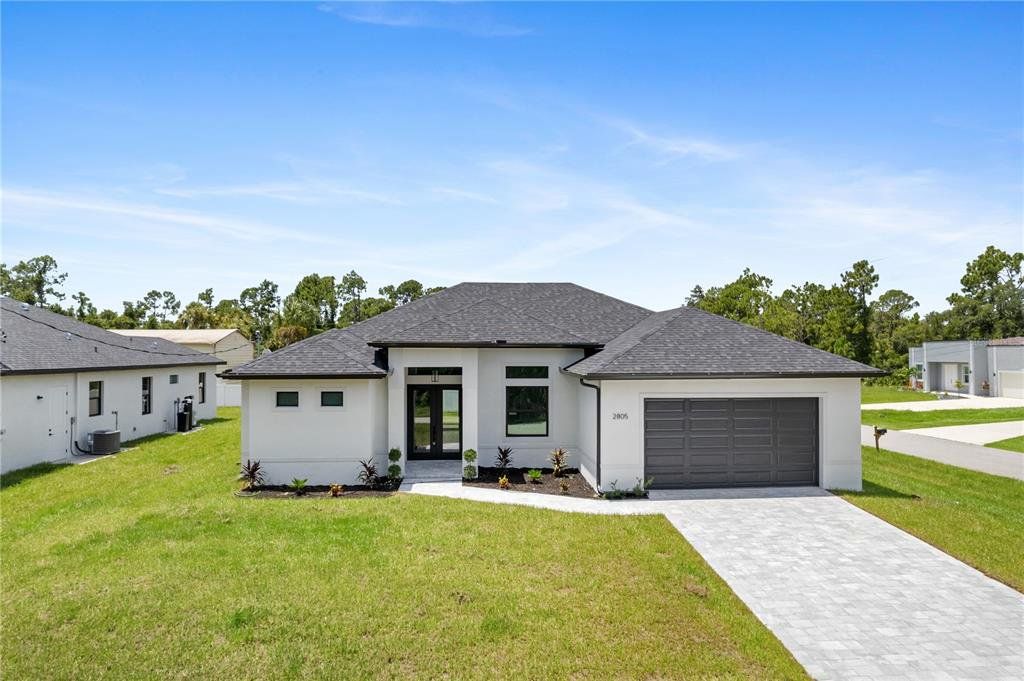 Front exterior of a new home in , North Port, FL, highlighting curb appeal (Image 1). Front exterior of a new home in , North Port, FL, highlighting curb appeal (Image 1).