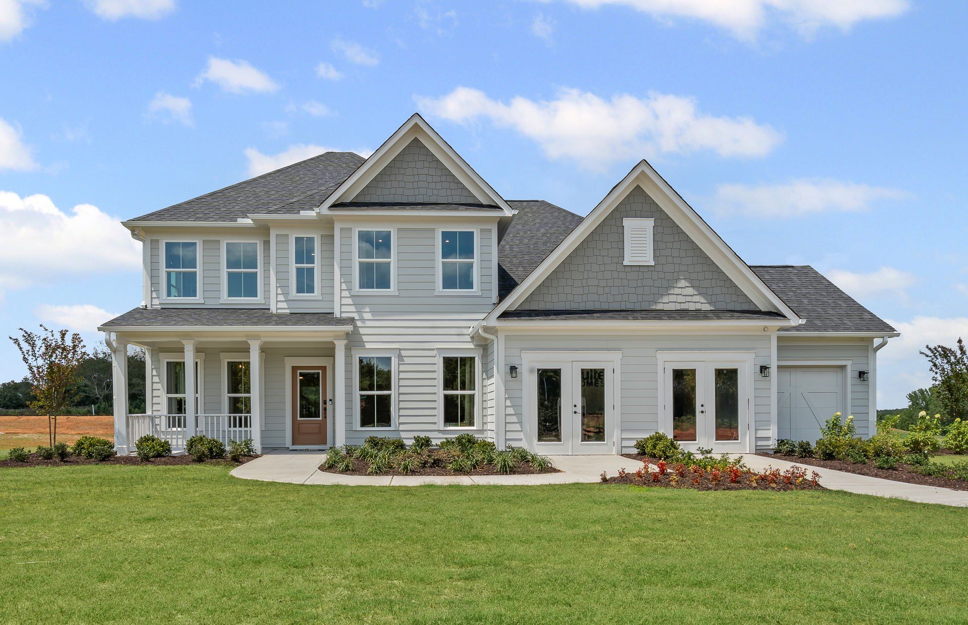 Front exterior of a new home in Creekside at Skelton, Hoschton, GA, highlighting curb appeal (Image 1). Front exterior of a new home in Creekside at Skelton, Hoschton, GA, highlighting curb appeal (Image 1).