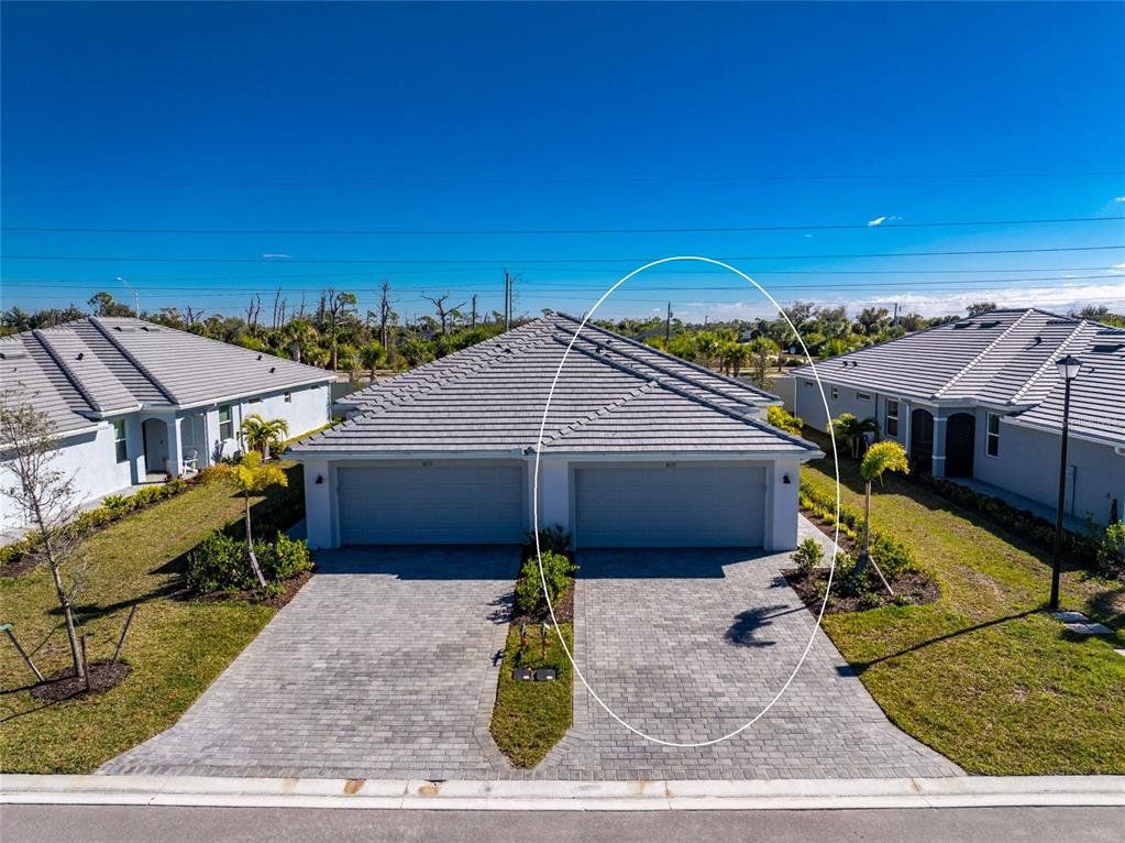 Front exterior of a new home in , Englewood, FL, highlighting curb appeal (Image 1). Front exterior of a new home in , Englewood, FL, highlighting curb appeal (Image 1).