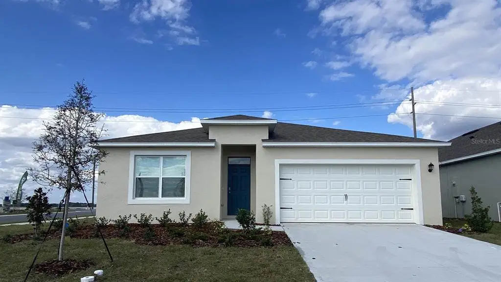 Front exterior of a new home in Magnolia Pointe, Umatilla, FL, highlighting curb appeal (Image 1).
