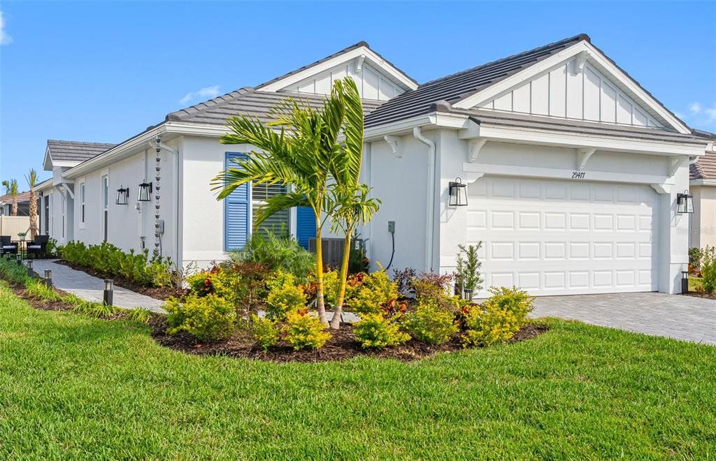 Front exterior of a new home in Esplanade at Wiregrass Ranch, Wesley Chapel, FL, highlighting curb appeal (Image 1). Front exterior of a new home in Esplanade at Wiregrass Ranch, Wesley Chapel, FL, highlighting curb appeal (Image 1).