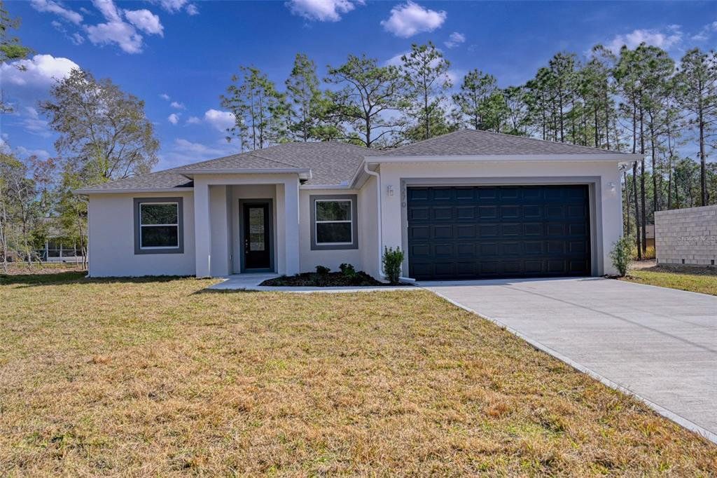 Front exterior of a new home in , Palm Bay, FL, highlighting curb appeal (Image 1). Front exterior of a new home in , Palm Bay, FL, highlighting curb appeal (Image 1).