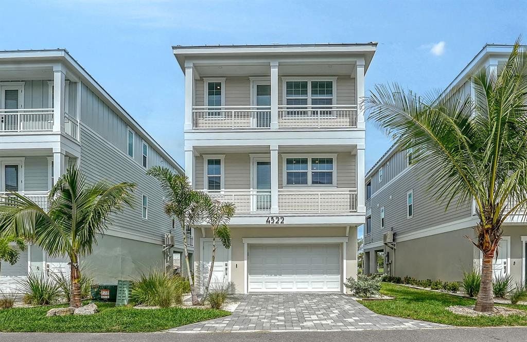 Front exterior of a new home in Hunters Point, Cortez, FL, highlighting curb appeal (Image 1). Front exterior of a new home in Hunters Point, Cortez, FL, highlighting curb appeal (Image 1).