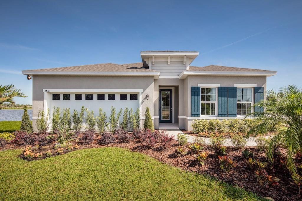 Front exterior of a new home in West Port Single Family Homes, Port Charlotte, FL, highlighting curb appeal (Image 1). Front exterior of a new home in West Port Single Family Homes, Port Charlotte, FL, highlighting curb appeal (Image 1).