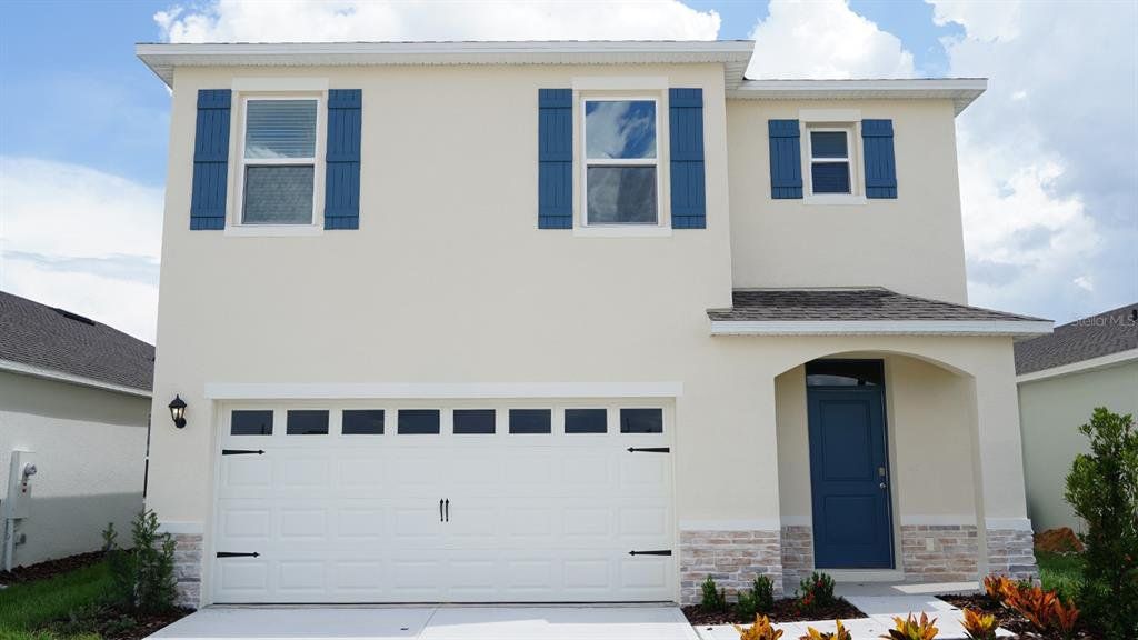 Front exterior of a new home in , Haines City, FL, highlighting curb appeal (Image 1). Front exterior of a new home in , Haines City, FL, highlighting curb appeal (Image 1).