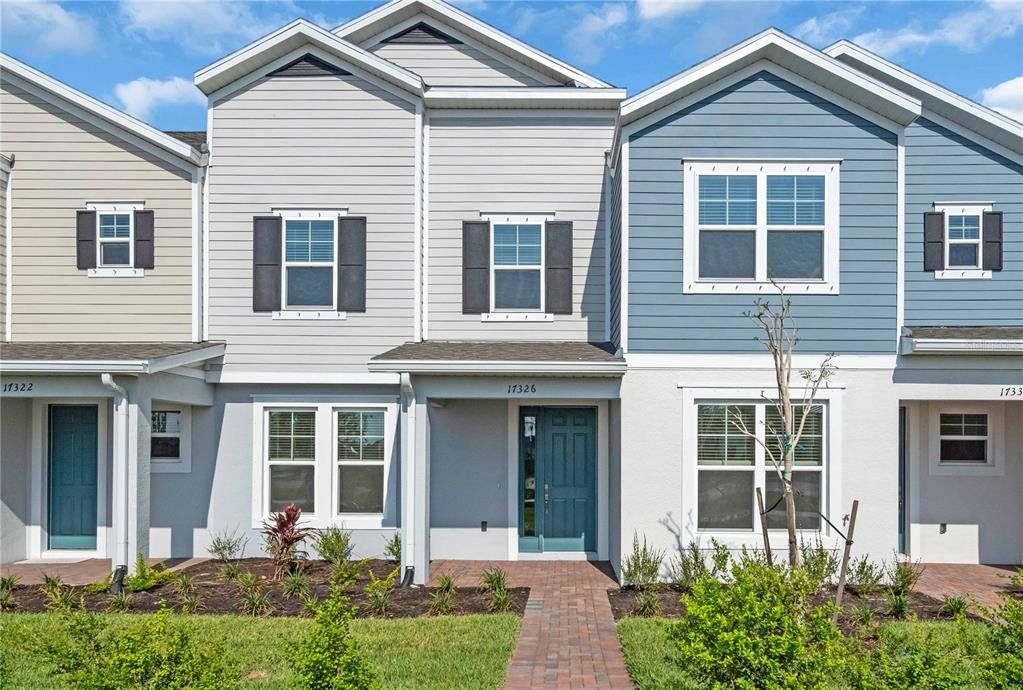Front exterior of a new home in The Residences at Emerson Park, Apopka, FL, highlighting curb appeal (Image 1).