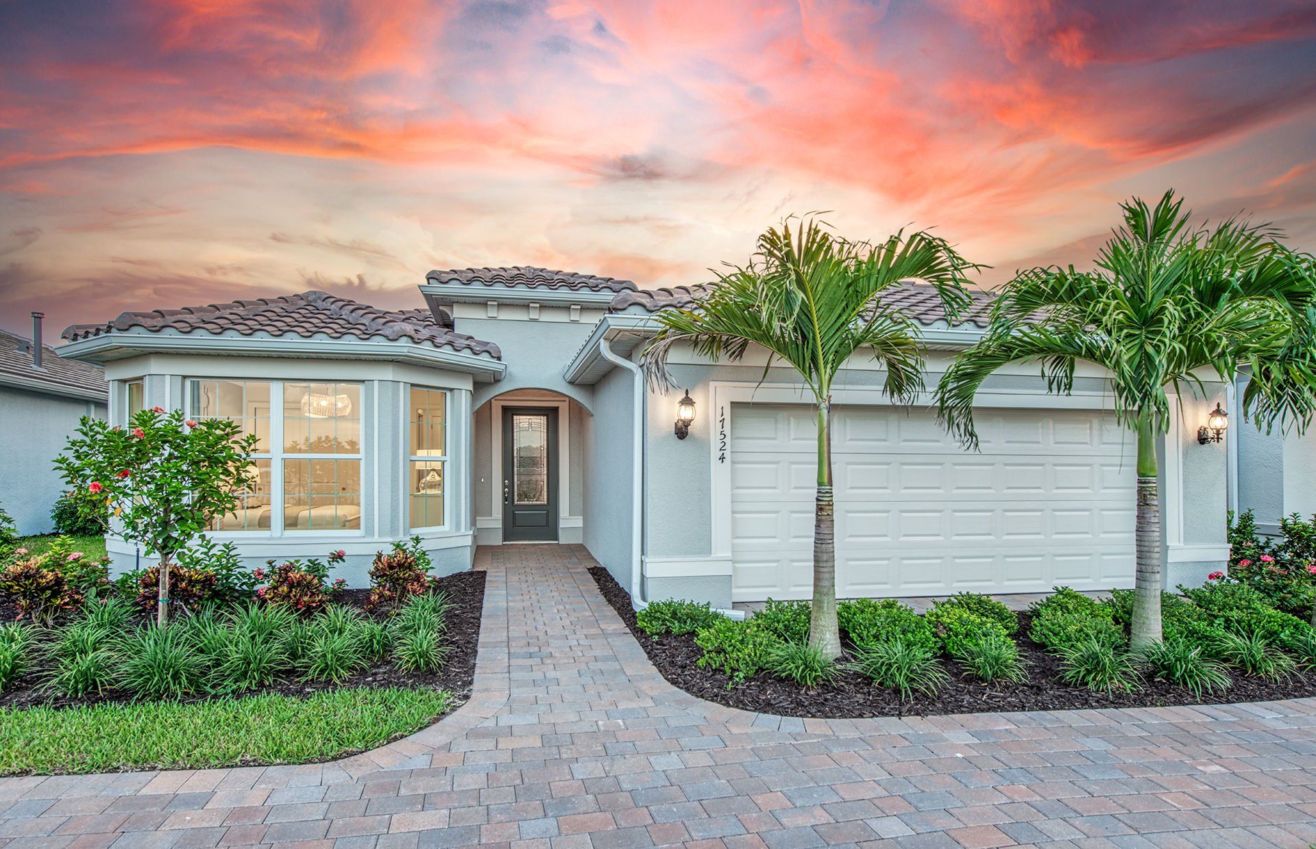 Front exterior of a new home in Del Webb Oak Creek, North Fort Myers, FL, highlighting curb appeal (Image 1). Front exterior of a new home in Del Webb Oak Creek, North Fort Myers, FL, highlighting curb appeal (Image 1).