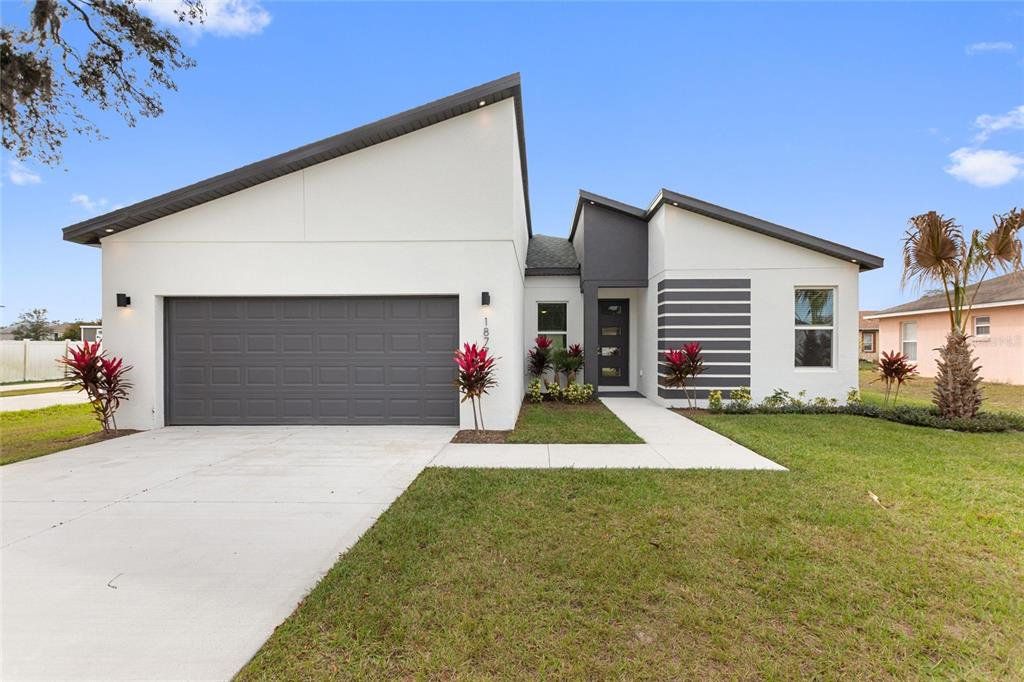 Front exterior of a new home in , Kissimmee, FL, highlighting curb appeal (Image 1). Front exterior of a new home in , Kissimmee, FL, highlighting curb appeal (Image 1).