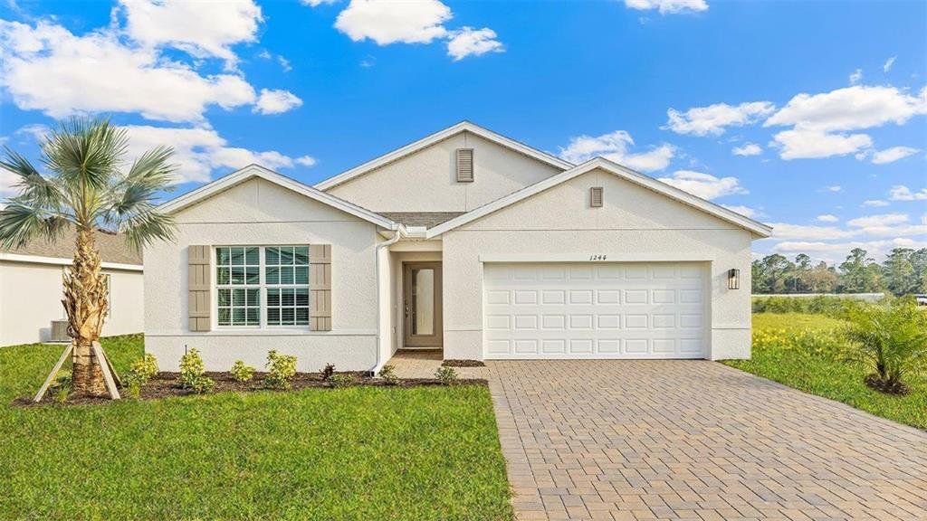 Front exterior of a new home in Seagrass - Express & Tradition, Punta Gorda, FL, highlighting curb appeal (Image 1). Front exterior of a new home in Seagrass - Express & Tradition, Punta Gorda, FL, highlighting curb appeal (Image 1).
