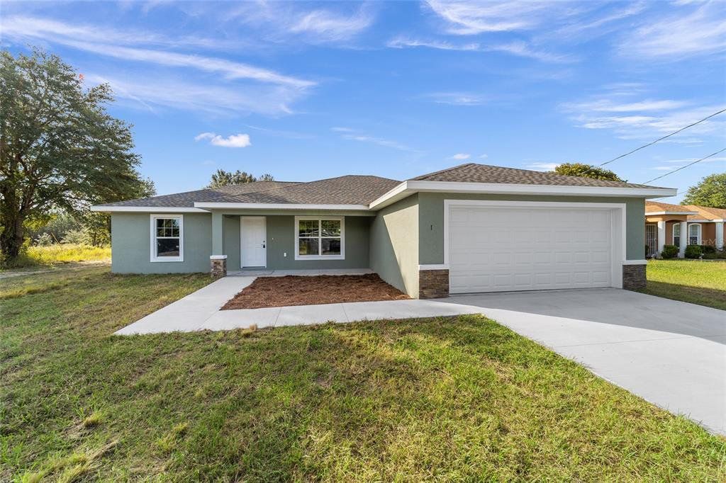 Front exterior of a new home in , Belleview, FL, highlighting curb appeal (Image 1).