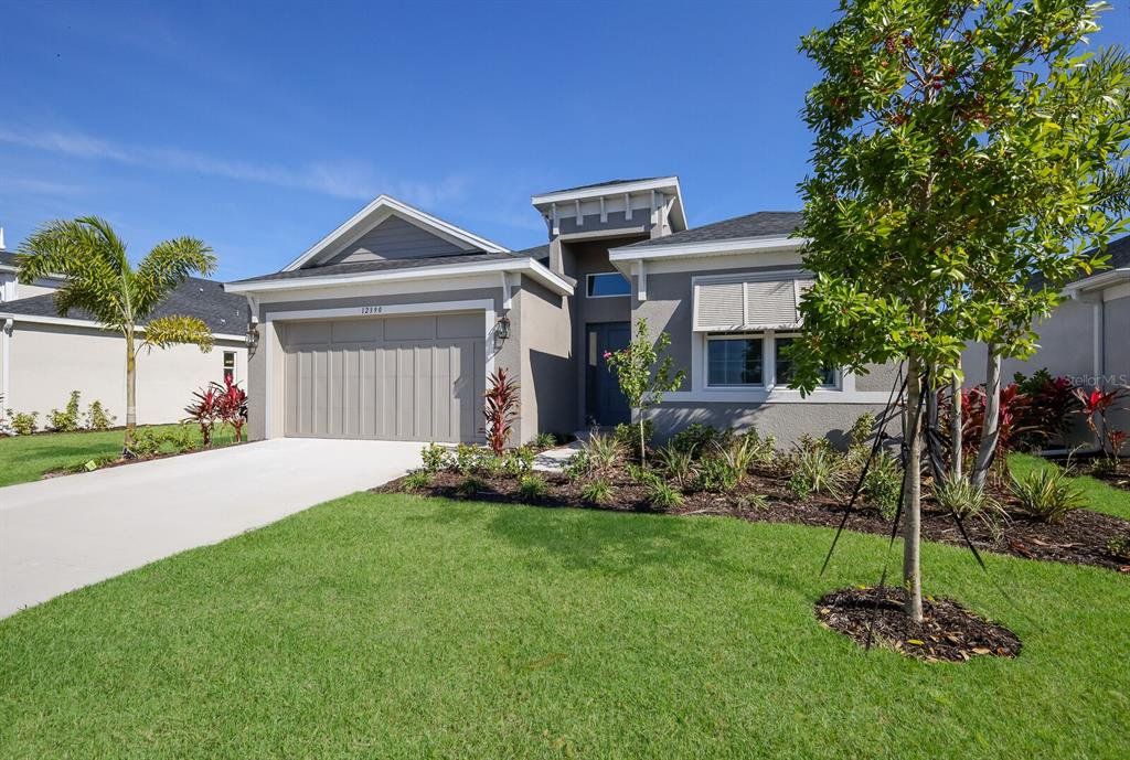 Front exterior of a new home in The Willows, Parrish, FL, highlighting curb appeal (Image 1). Front exterior of a new home in The Willows, Parrish, FL, highlighting curb appeal (Image 1).