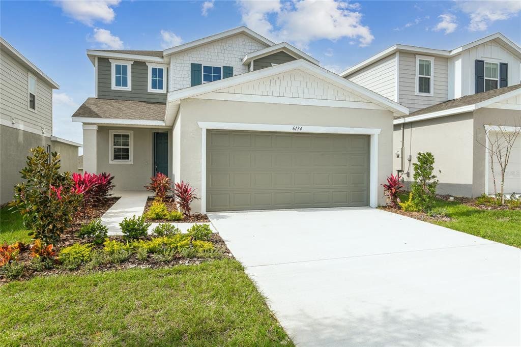 Front exterior of a new home in Seasons at Scenic Terrace, Lake Hamilton, FL, highlighting curb appeal (Image 1). Front exterior of a new home in Seasons at Scenic Terrace, Lake Hamilton, FL, highlighting curb appeal (Image 1).