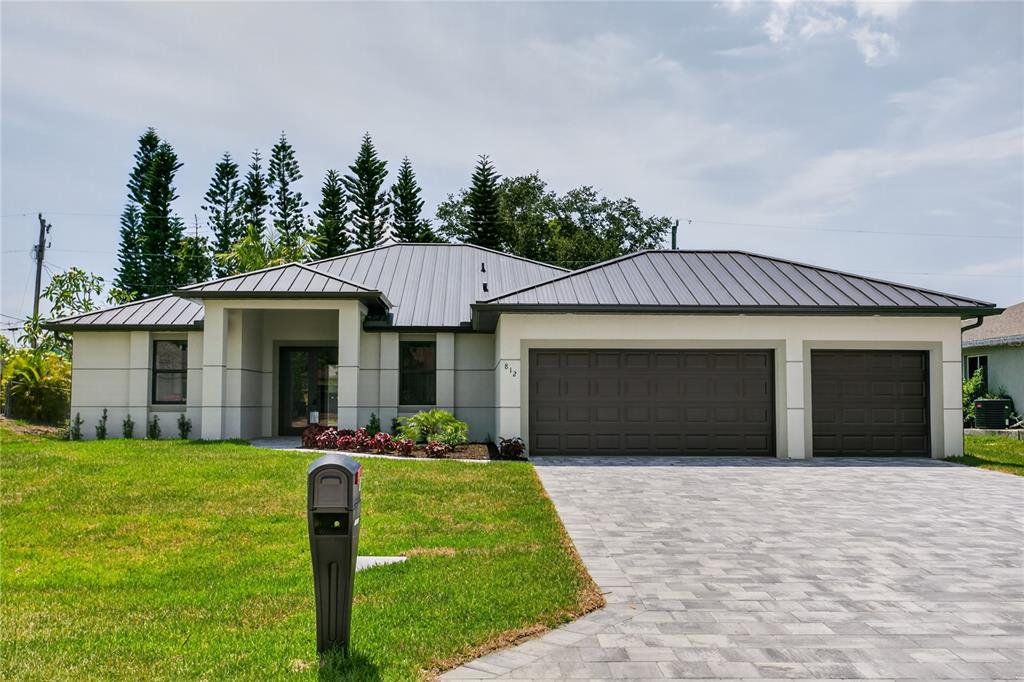 Front exterior of a new home in , Cape Coral, FL, highlighting curb appeal (Image 1). Front exterior of a new home in , Cape Coral, FL, highlighting curb appeal (Image 1).