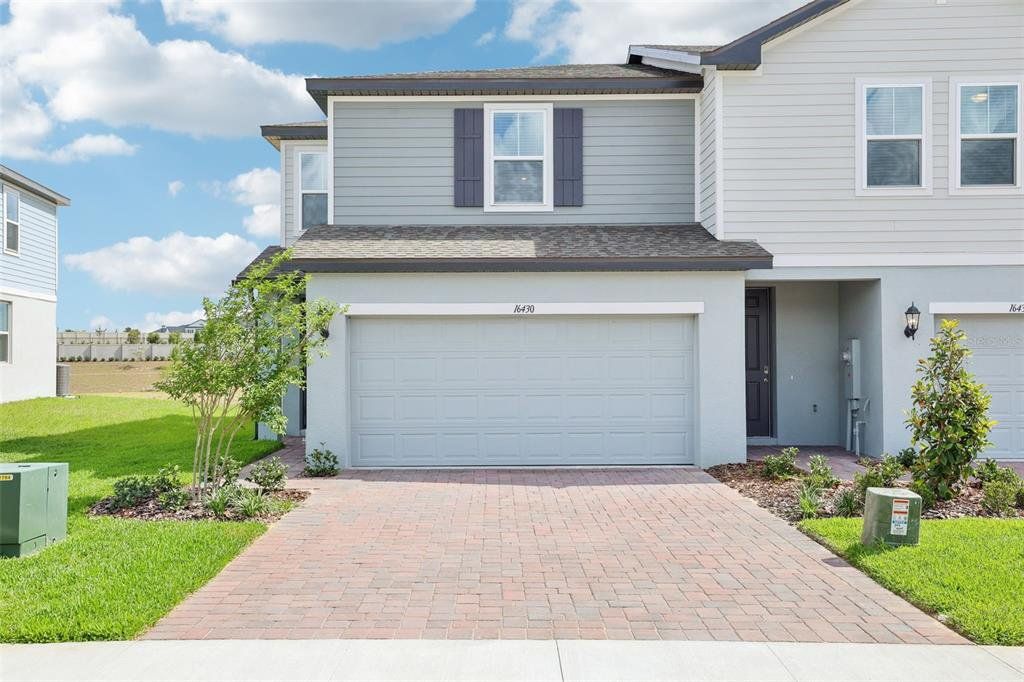 Front exterior of a new home in Cagan Crossings West, Clermont, FL, highlighting curb appeal (Image 1). Front exterior of a new home in Cagan Crossings West, Clermont, FL, highlighting curb appeal (Image 1).