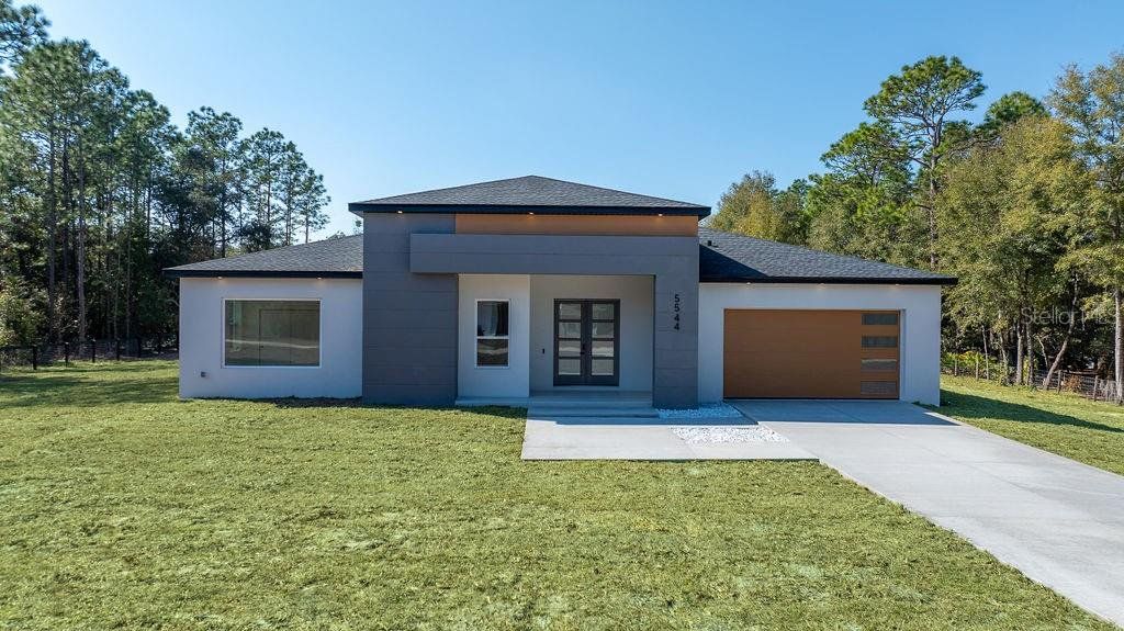 Front exterior of a new home in , Ocala, FL, highlighting curb appeal (Image 1). Front exterior of a new home in , Ocala, FL, highlighting curb appeal (Image 1).