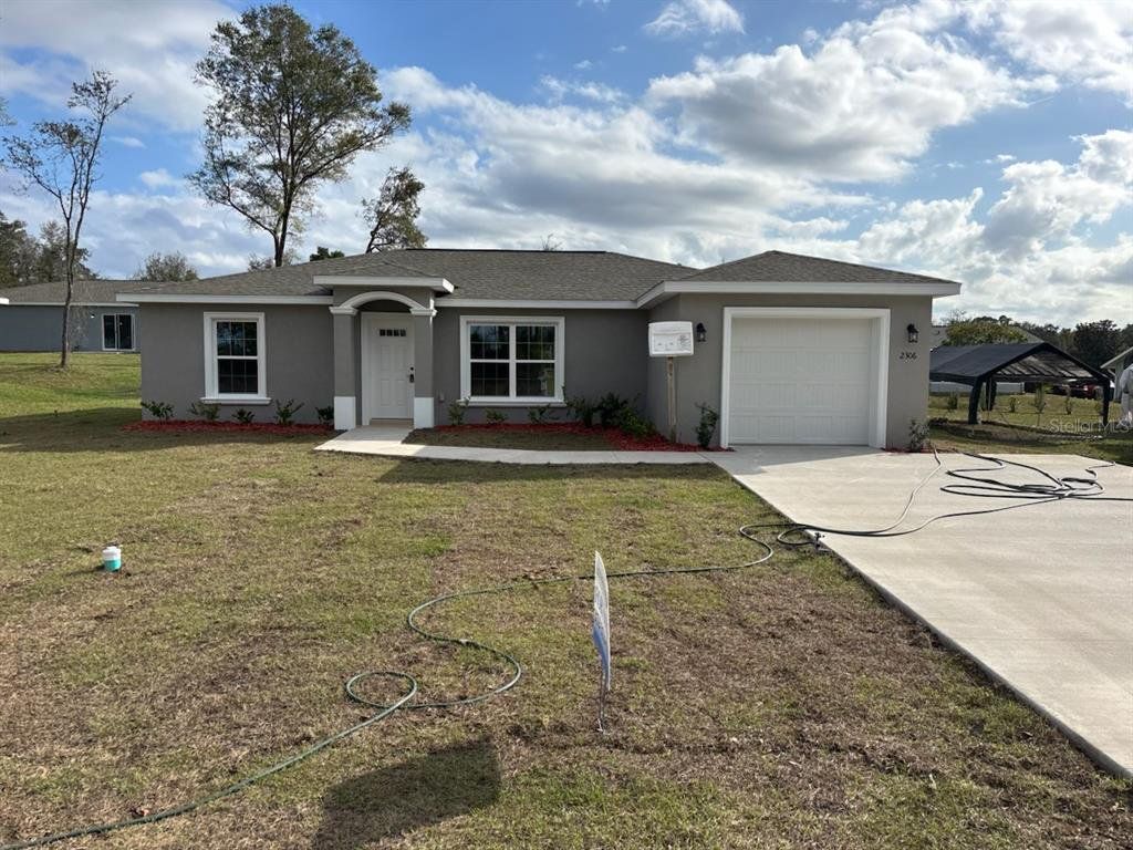 Front exterior of a new home in , Citrus Springs, FL, highlighting curb appeal (Image 1). Front exterior of a new home in , Citrus Springs, FL, highlighting curb appeal (Image 1).