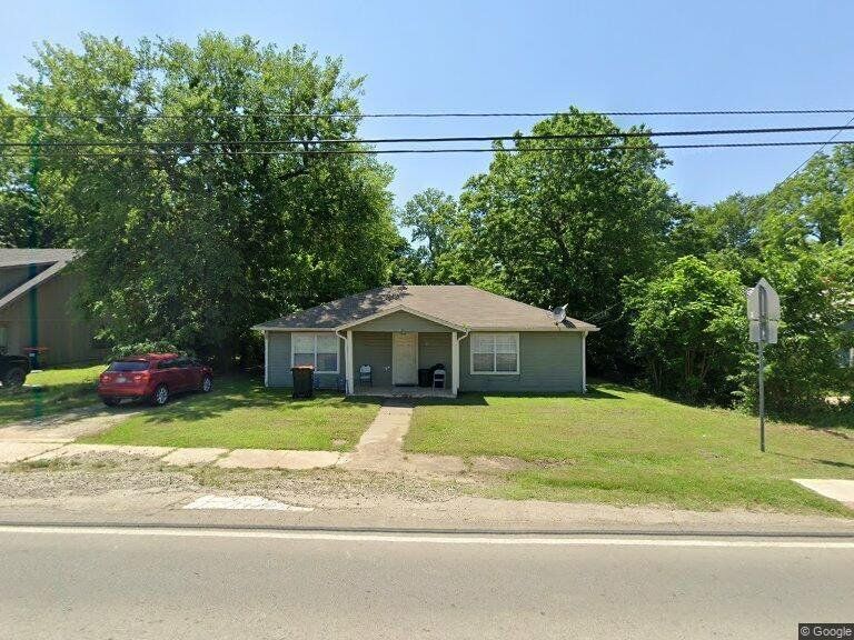 Bungalow-style house with a front yard and covered porch