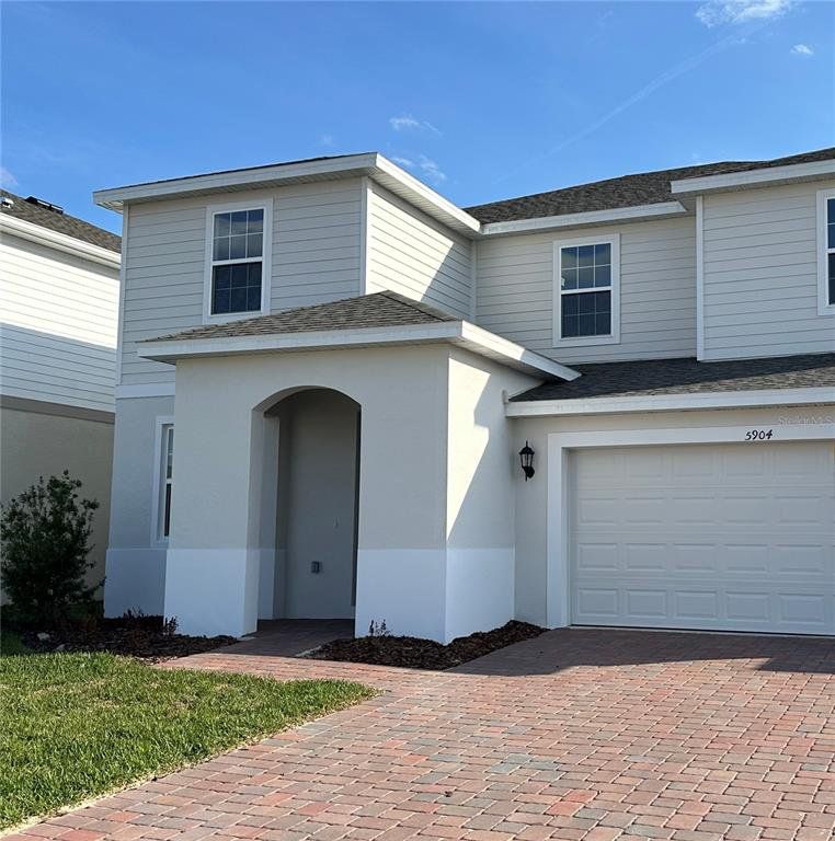 Front exterior of a new home in Trinity Place, St. Cloud, FL, highlighting curb appeal (Image 1). Front exterior of a new home in Trinity Place, St. Cloud, FL, highlighting curb appeal (Image 1).