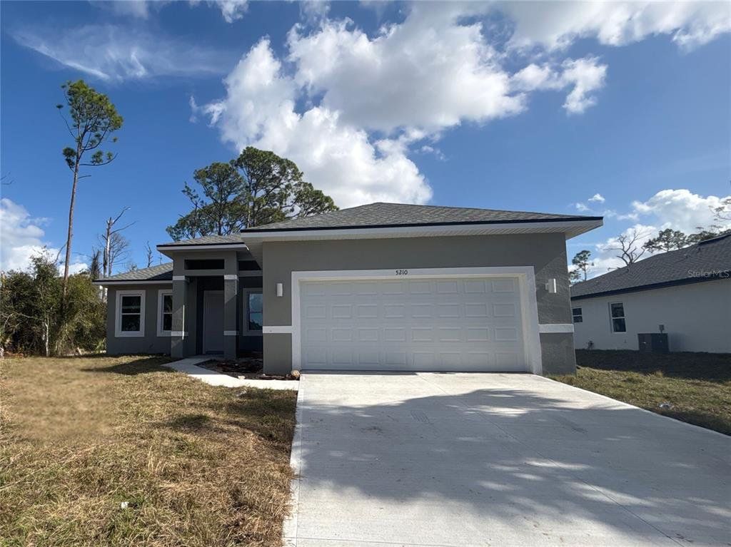 Front exterior of a new home in , North Port, FL, highlighting curb appeal (Image 1). Front exterior of a new home in , North Port, FL, highlighting curb appeal (Image 1).