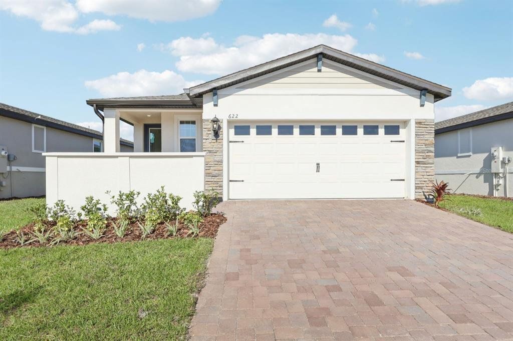 Front exterior of a new home in Springs at Lake Alfred - Classic Series, Lake Alfred, FL, highlighting curb appeal (Image 1). Front exterior of a new home in Springs at Lake Alfred - Classic Series, Lake Alfred, FL, highlighting curb appeal (Image 1).