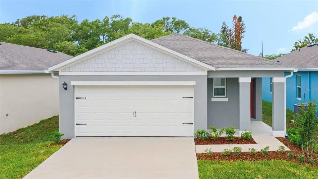 Front exterior of a new home in Kindred, Kissimmee, FL, highlighting curb appeal (Image 1). Front exterior of a new home in Kindred, Kissimmee, FL, highlighting curb appeal (Image 1).