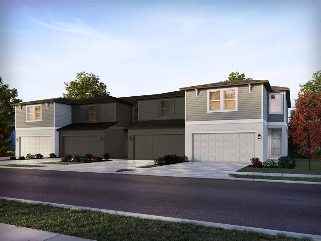 Front exterior of a new home in The Meadow at Crossprairie Townes, St. Cloud, FL, highlighting curb appeal (Image 1). Front exterior of a new home in The Meadow at Crossprairie Townes, St. Cloud, FL, highlighting curb appeal (Image 1).