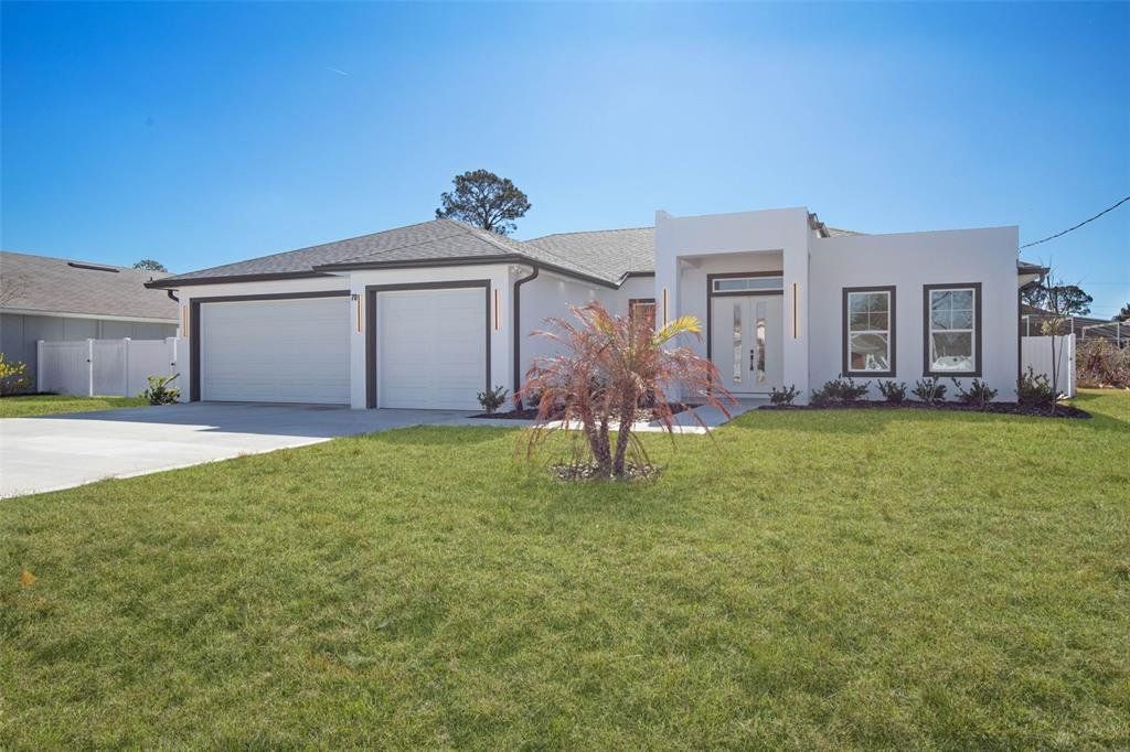 Front exterior of a new home in , Palm Coast, FL, highlighting curb appeal (Image 1). Front exterior of a new home in , Palm Coast, FL, highlighting curb appeal (Image 1).