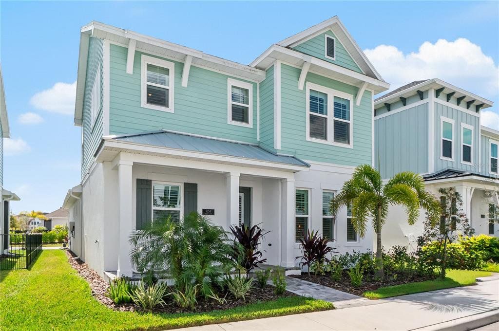 Front exterior of a new home in Emerald Landing at Waterside at Lakewood Ranch – Cottage Series, Sarasota, FL, highlighting curb appeal (Image 1). Front exterior of a new home in Emerald Landing at Waterside at Lakewood Ranch – Cottage Series, Sarasota, FL, highlighting curb appeal (Image 1).
