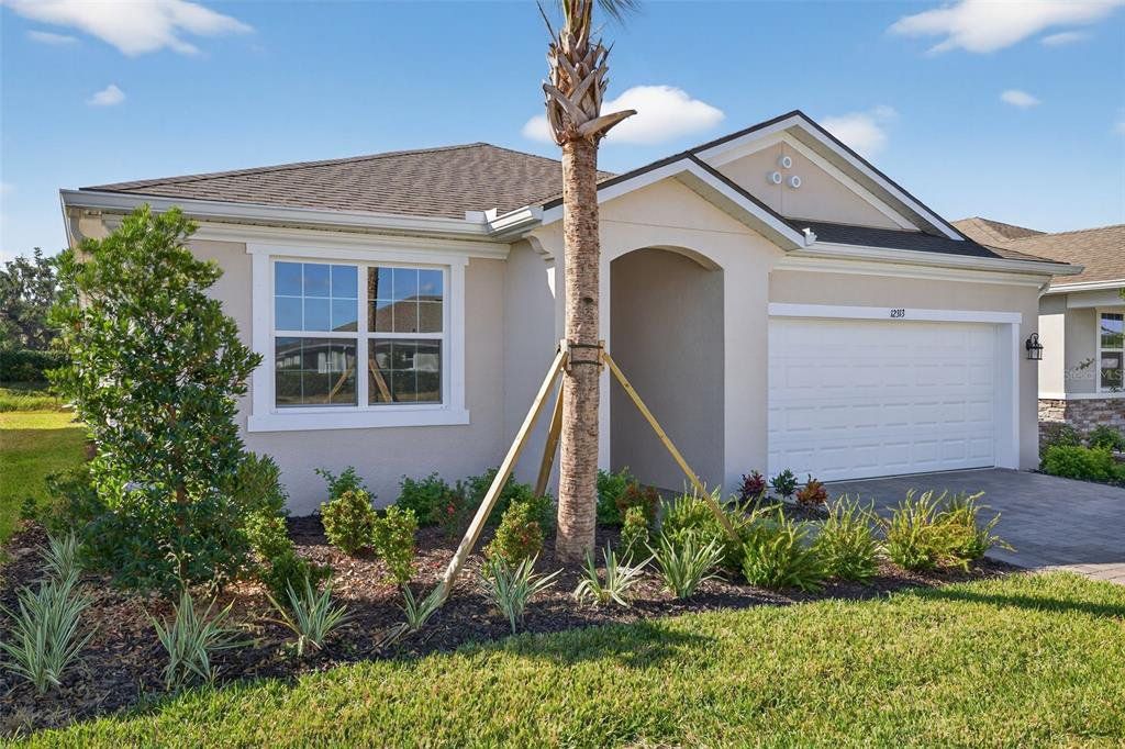 Front exterior of a new home in Windwater, Parrish, FL, highlighting curb appeal (Image 1). Front exterior of a new home in Windwater, Parrish, FL, highlighting curb appeal (Image 1).
