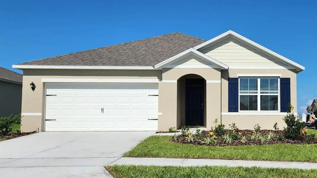 Front exterior of a new home in Tradewinds at Hammock Reserve, Haines City, FL, highlighting curb appeal (Image 1). Front exterior of a new home in Tradewinds at Hammock Reserve, Haines City, FL, highlighting curb appeal (Image 1).