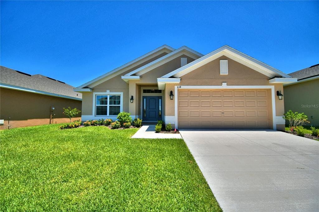 Front exterior of a new home in Magnolia Park, Haines City, FL, highlighting curb appeal (Image 1).