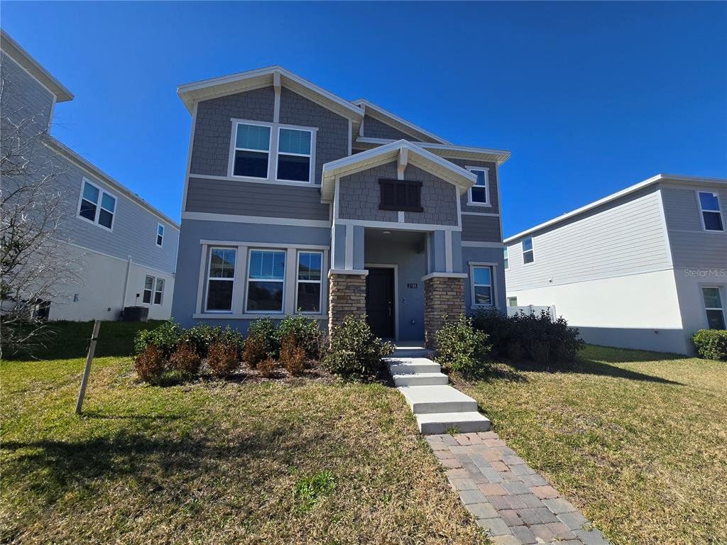 Front exterior of a new home in Rhett's Ridge, Apopka, FL, highlighting curb appeal (Image 1). Front exterior of a new home in Rhett's Ridge, Apopka, FL, highlighting curb appeal (Image 1).
