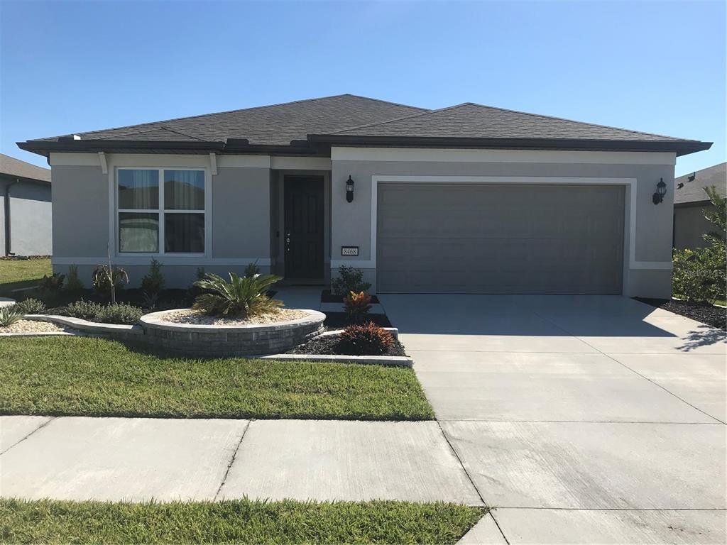 Front exterior of a new home in Del Webb Stone Creek, Ocala, FL, highlighting curb appeal (Image 1). Front exterior of a new home in Del Webb Stone Creek, Ocala, FL, highlighting curb appeal (Image 1).