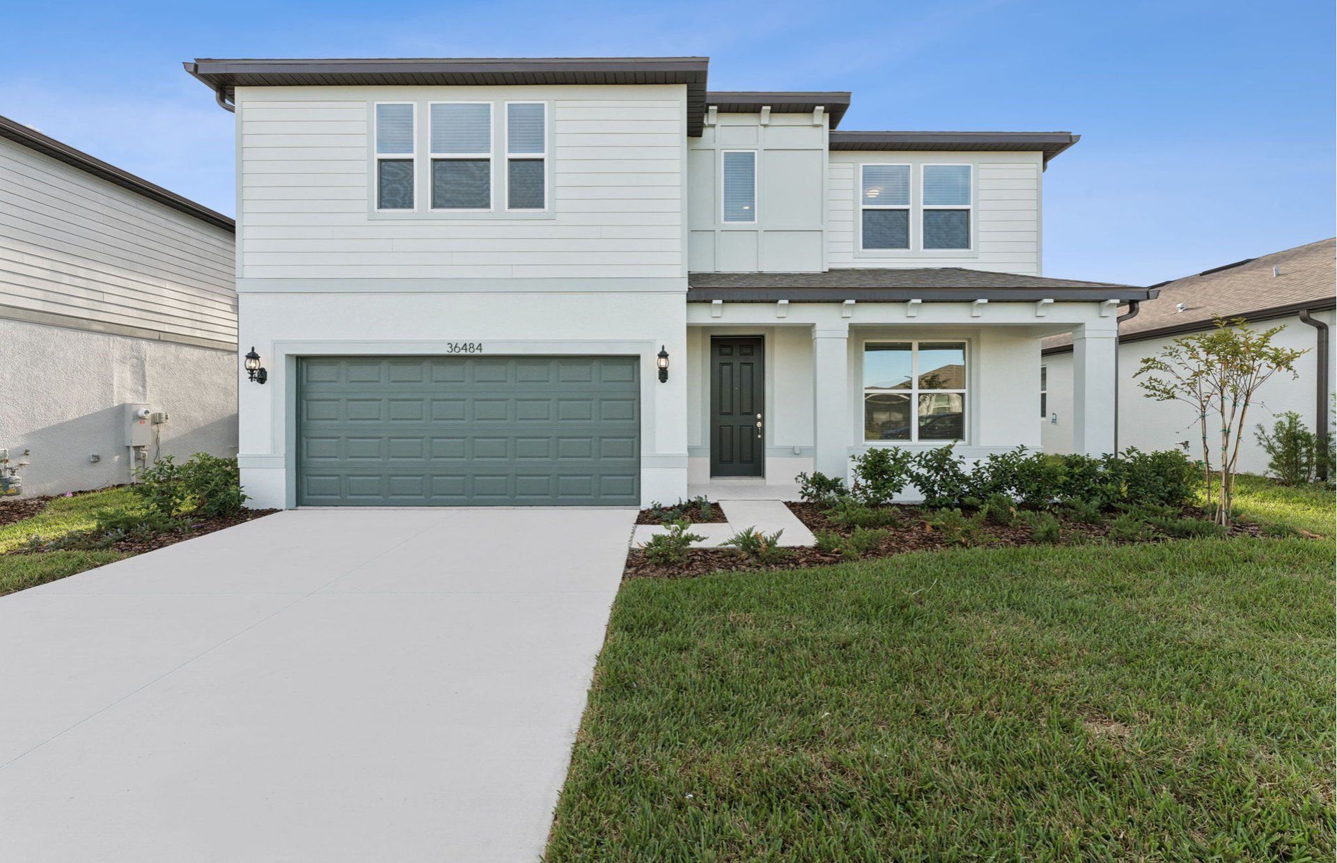 Front exterior of a new home in Riverwood, Zephyrhills, FL, highlighting curb appeal (Image 1). Front exterior of a new home in Riverwood, Zephyrhills, FL, highlighting curb appeal (Image 1).