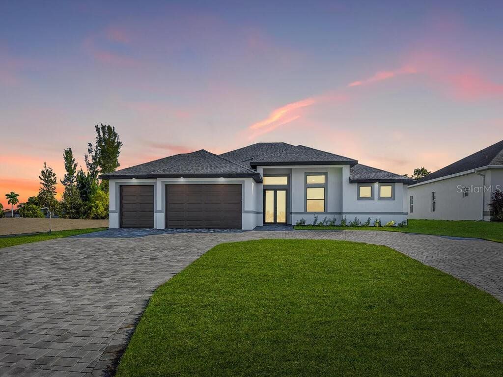 Front exterior of a new home in , Cape Coral, FL, highlighting curb appeal (Image 1). Front exterior of a new home in , Cape Coral, FL, highlighting curb appeal (Image 1).
