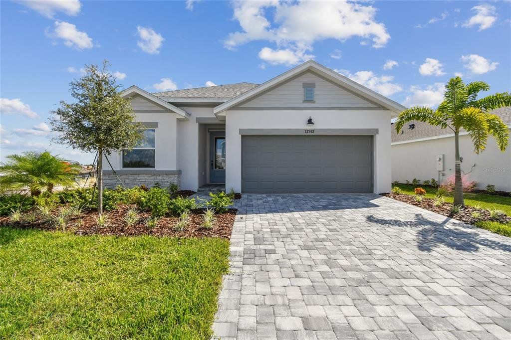 Front exterior of a new home in North River Ranch – Garden Series, Parrish, FL, highlighting curb appeal (Image 1). Front exterior of a new home in North River Ranch – Garden Series, Parrish, FL, highlighting curb appeal (Image 1).