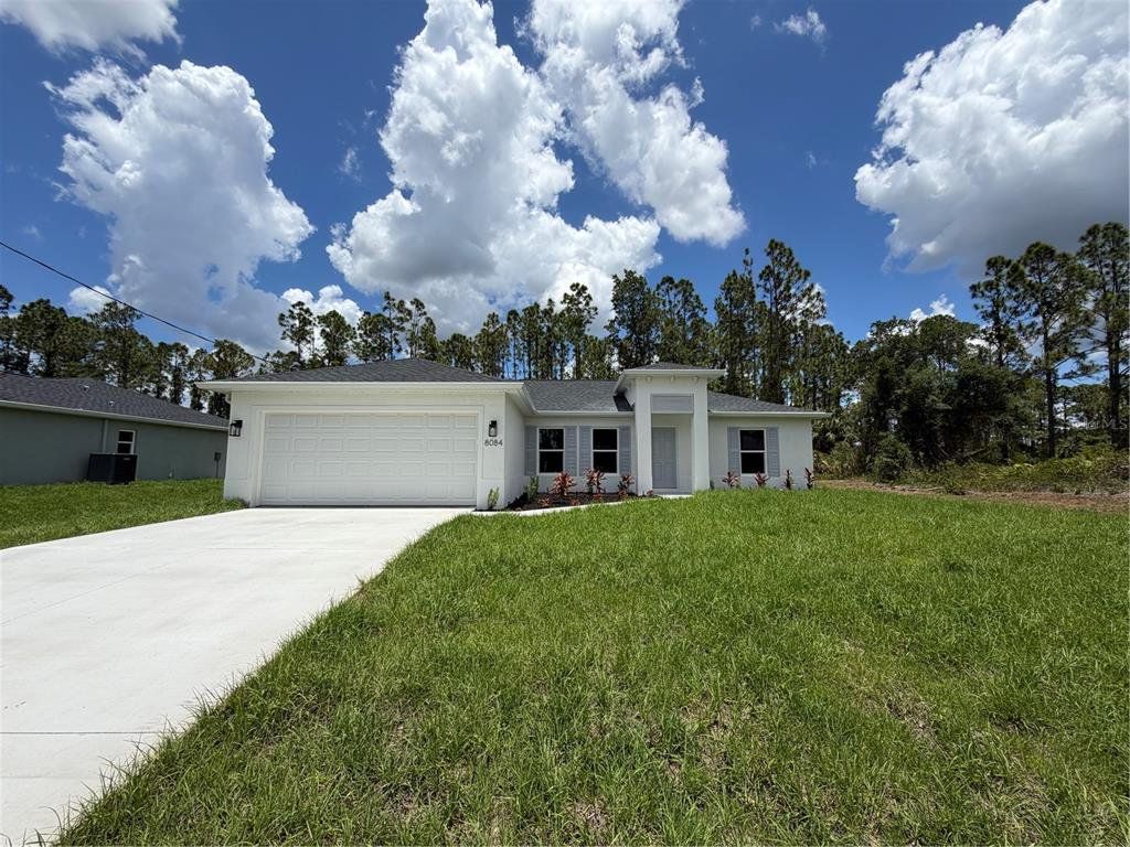 Front exterior of a new home in , North Port, FL, highlighting curb appeal (Image 1). Front exterior of a new home in , North Port, FL, highlighting curb appeal (Image 1).
