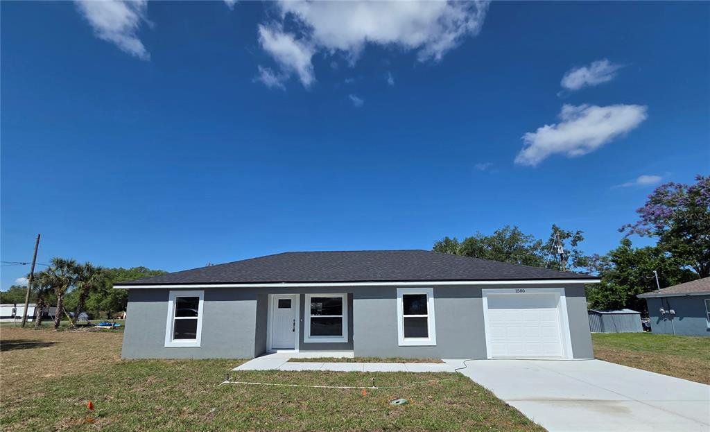 Front exterior of a new home in , Lake Wales, FL, highlighting curb appeal (Image 1). Front exterior of a new home in , Lake Wales, FL, highlighting curb appeal (Image 1).