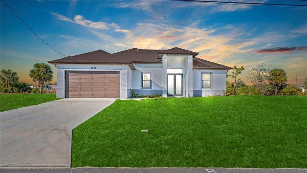 Front exterior of a new home in , Cape Coral, FL, highlighting curb appeal (Image 1). Front exterior of a new home in , Cape Coral, FL, highlighting curb appeal (Image 1).